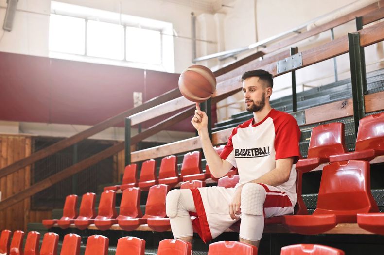 Basketball fan spinning ball on finger