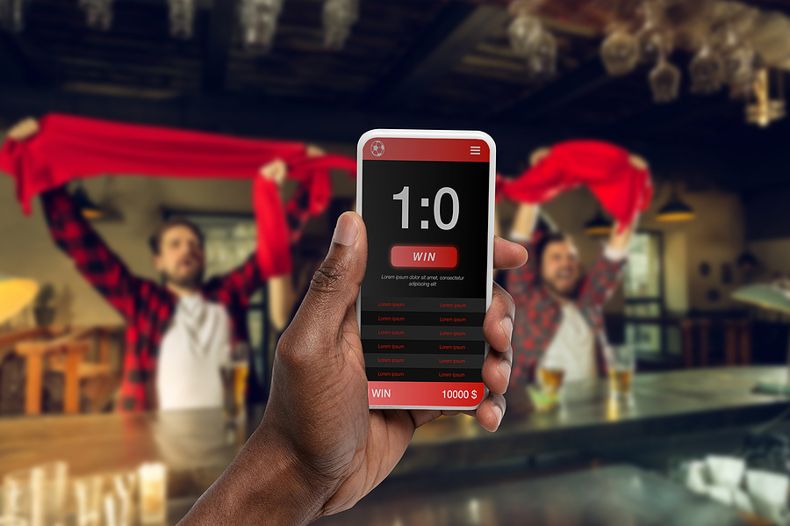 Man Holding Smartphone With Betting App
