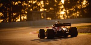 F1 car driving in the sunset