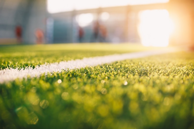 Blurred Football Training Pitch in Sunshine