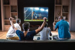 Friends watching sport on TV