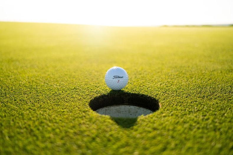 Golf Ball Next to Hole