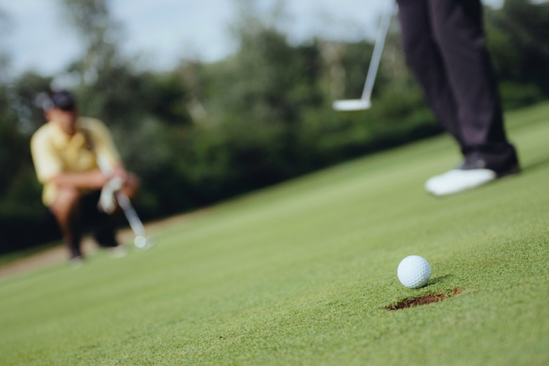 Golfers putting