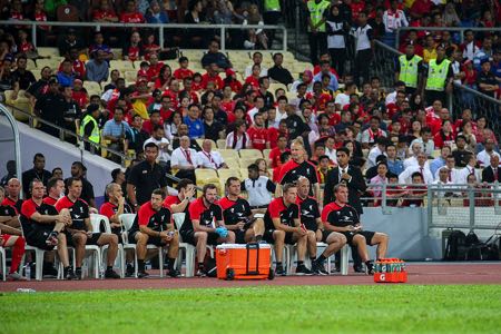 Liverpool players sitting on a bench - concept of substitutions