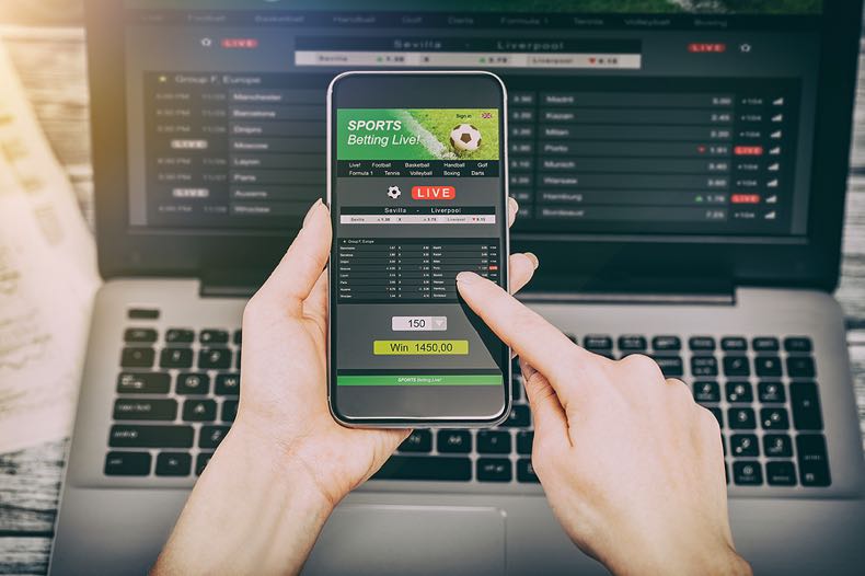 Sports betting on mobile and laptop